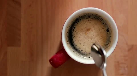 Stirring cup of coffee overhead 스톡 동영상 11889786