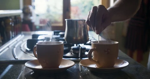 Stirring cup of coffee with silver spoon Stock Footage 97266424