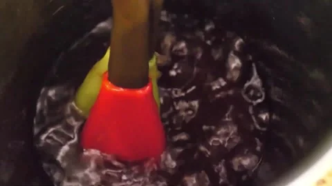 Stirring Dark Liquid in Pot with Silicone Spatula Video stock 343587992