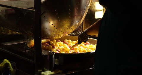 Stirring deep fried sweet potato balls in large frying wok with press Vídeo Stock 341099068