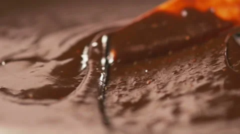Stirring delicious melted chocolate with a knife in slow motion Stock Footage 59665379