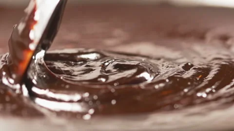 Stirring delicious melted chocolate with a spoon in slow motion Stock Footage 59665564