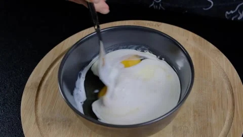 Stirring Eggs in Bowl with Fork during Cooking Vidéo 341430203
