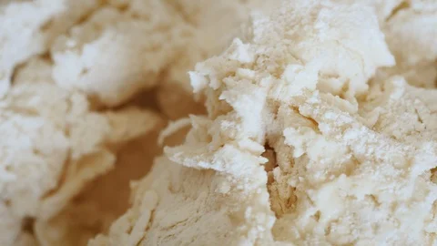 Stirring Flour and Yeast into Bread Dough Stock Footage 129840999