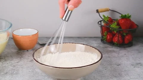 Stirring flour with a whisk Stock Footage 256606509