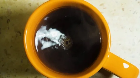 Stirring fresh made coffee in a cup. Closeup Stock Footage 99730919