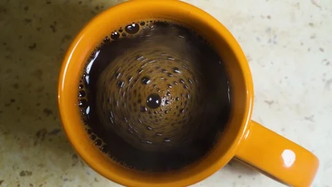 Stirring fresh made coffee in a cup. Closeup Stock Footage 99731306