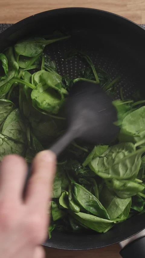 Stirring Fresh Spinach In Pan Top View Vertical Видео 337190343