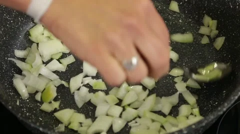 Stirring fried onion in a pan Stock Footage 49782992