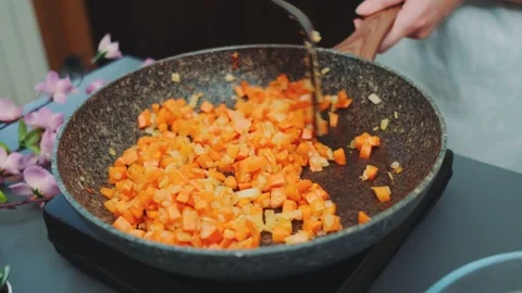 Stirring fried vegetables with a kitchen spatula Stock-Footage 249079061