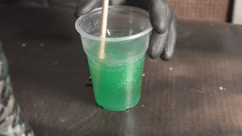 Stirring Green Epoxy Resin with Glitter in Plastic Cup Stock Footage 346691295
