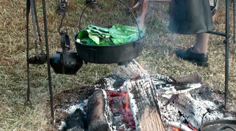 Stirring greens over a open flame Stock Footage 32845729