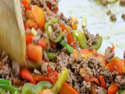 Stirring ground beef into cooked vegetables. Stock Footage 72387889