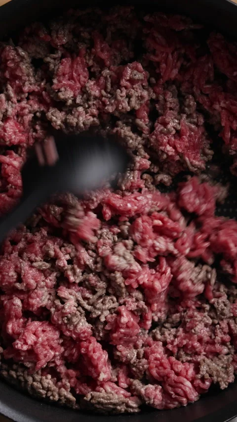 Stirring Ground Beef with Silicone Spoon in Pan Close Up Vertical Top View Видео 336577170