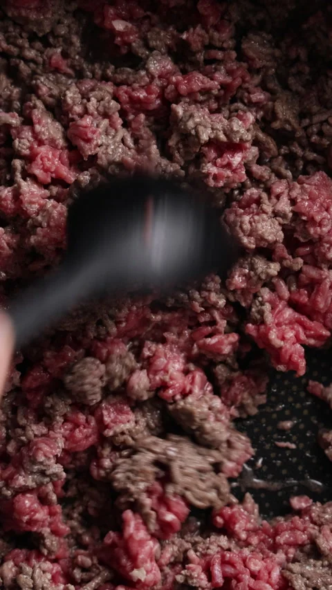 Stirring Ground Beef with Silicone Spoon in Pan Extreme Close Up Vertical Видео 336577333