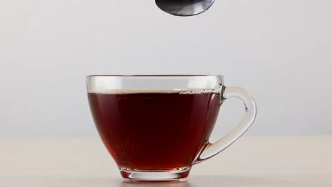 Stirring Hot Black Tea in Clear Glass Cup With Spoon Stock Footage 345103076