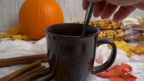 Stirring hot chocolate or coffee with a spoon fall setting Stock Footage 119220448