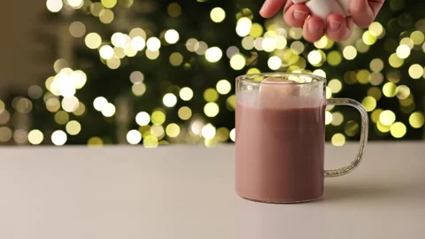 Stirring Hot Cocoa with Marshmallows and Christmas Bokeh Lights Stock Footage 324785216