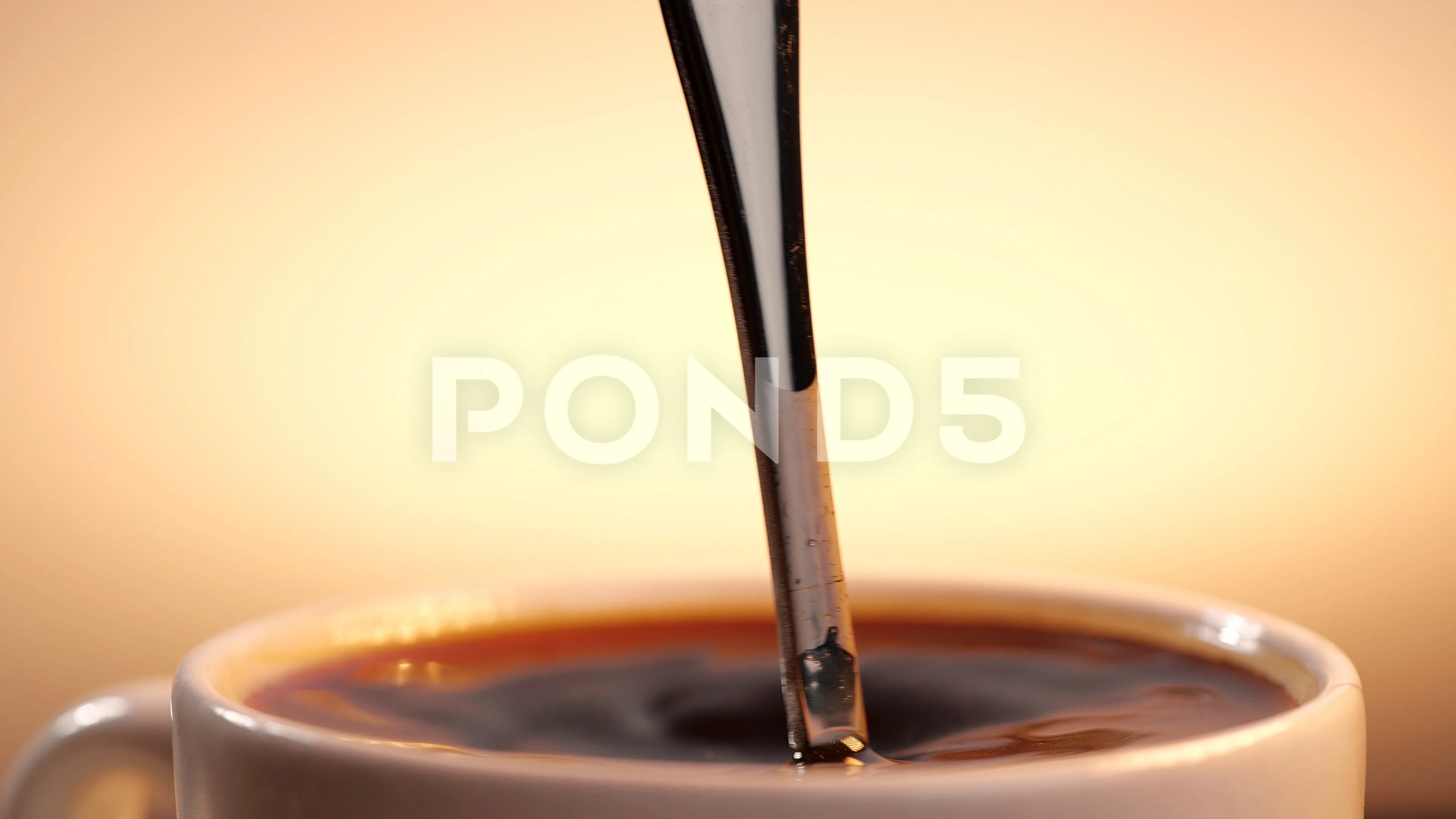 Stir the hot coffee in a cup with a spoo, Stock Video