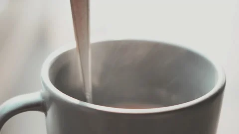 Stirring hot coffee cup with spoon. Hot coffee with steam Video stock 148316044