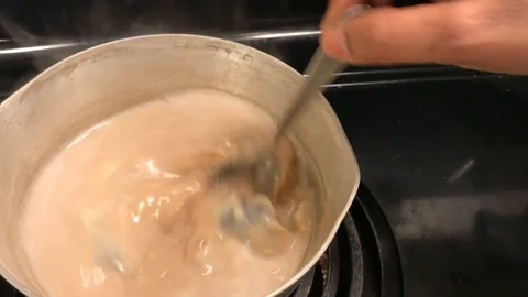 Stirring hot ginger chai tea Stock Footage 122051748