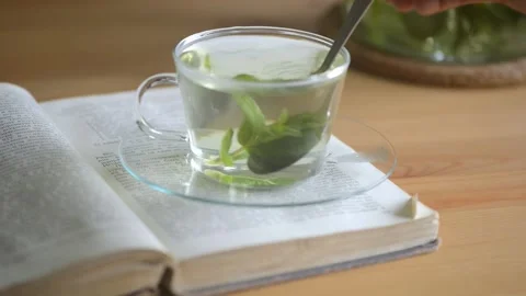 Stirring hot mint tea with teaspoon. Stock Footage 160832785