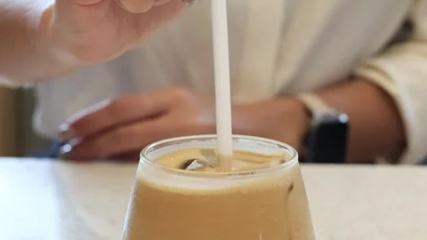 Stirring Iced Coffee with Straw 库存影片 300664174