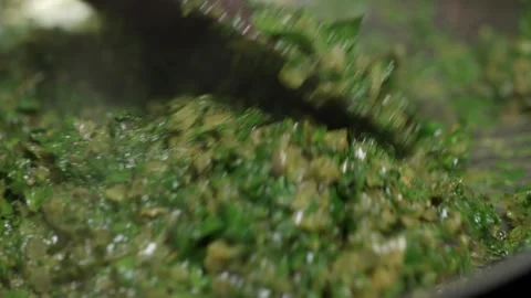 Stirring the ingredients for a cafe de paris sauce in a hot pan. Chef uses Stock Footage 256057085