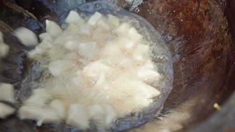 Stirring lamb tail fat rendering in cauldron during first stage of traditio.. Stock Footage 319660884