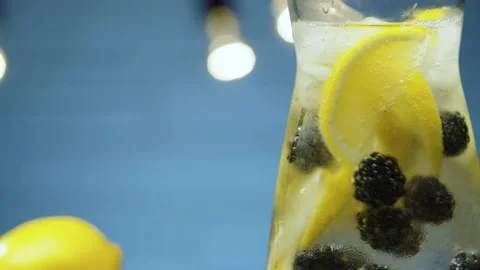 Stirring lemonade with dewberry Stock Footage 143094407