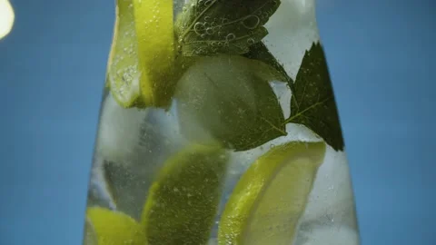 Stirring lemonade with lime and mint Stock Footage 142882892