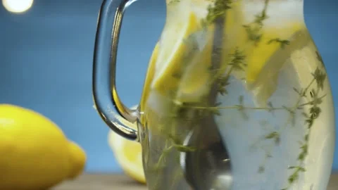 Stirring lemonade with thyme Stock Footage 142882841