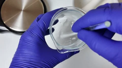 Stirring Liquid in Glass Beaker with Spatula Stock-Footage 345259424