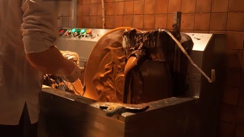 Stirring machine hot chocolate. the melted dense mass rotates in a large vat Stock Footage 102830888