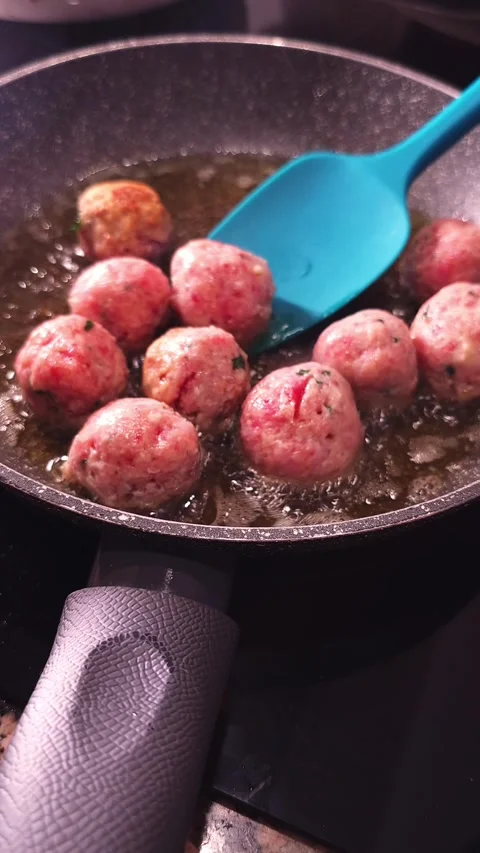 Stirring meatballs in frying pan. Stock Footage 345041421