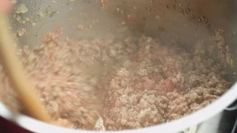 Stirring mincemeat with mashed tomatoes in a pot. Stock Footage 171936681