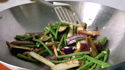 Stirring Mixed Vegetables of String Beans and Eggplant in a Wok Stock Footage 234882184