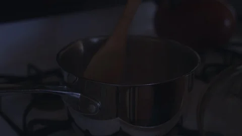 Stirring a mixture in a pot of boiling water with a wooden spoon. 4k UHD. Stock Footage 89543731
