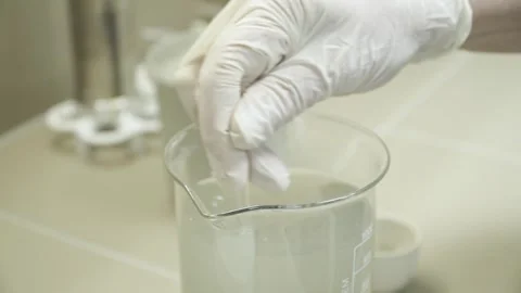 Stirring a mixture sample for aerated concrete 스톡 동영상 304360586