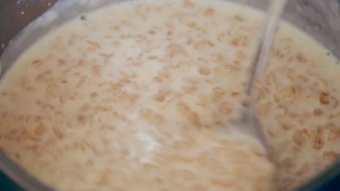 Stirring oatmeal in a pan Video stock 133341366