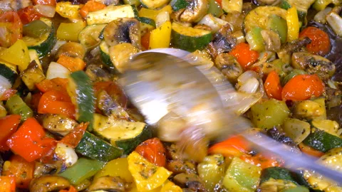 Stirring oven roasted vegetables. Video stock 135594719