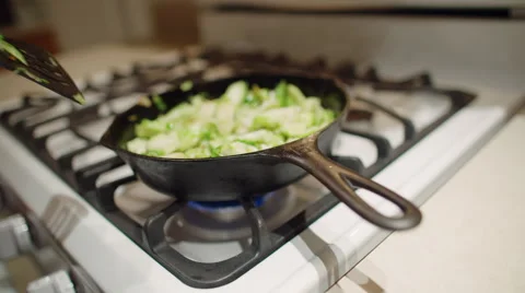 Stirring a pan full of sliced sprouts 4K Stock Footage 48045299