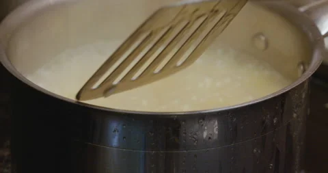 Stirring a pot of boiling rice Stock Footage 130689478