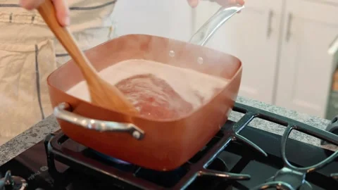 Stirring pot over stove Stock Footage 157705271