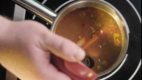 Stirring a pot of vegetable soup close up Stock Footage 170233012