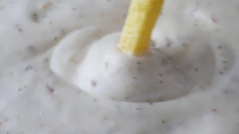 Stirring ranch dressing with a yellow veggie straw Stock Footage 89727815