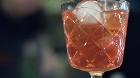 Stirring red-orange juice or cocktail Stock-Footage 129087809