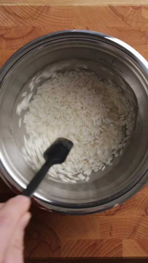 Stirring Rice With Silicone Spatula Vertical Top View Видео 334629908