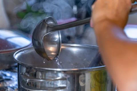 Stirring the risotto rice in the pan with hot water. Stock Photos