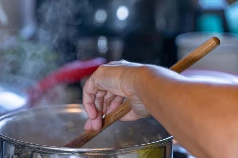 Stirring the risotto rice in the pan with hot water. Stock Photos